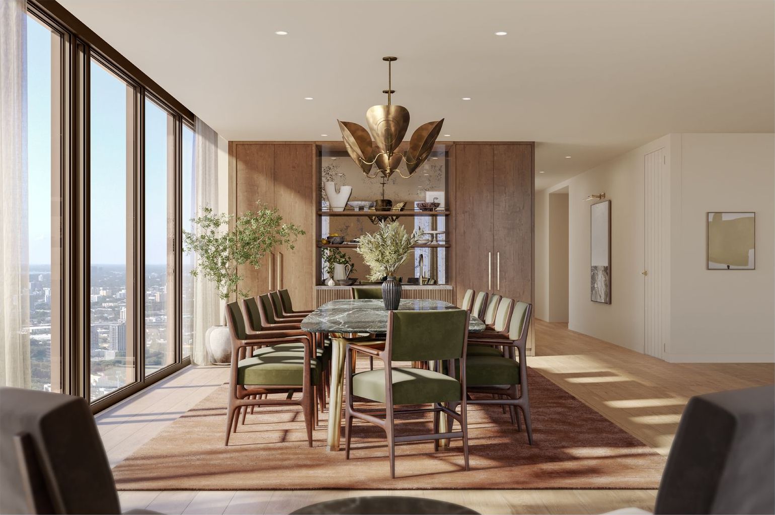 Dining room with a long table and bay views at Villa Miami, developer rendering