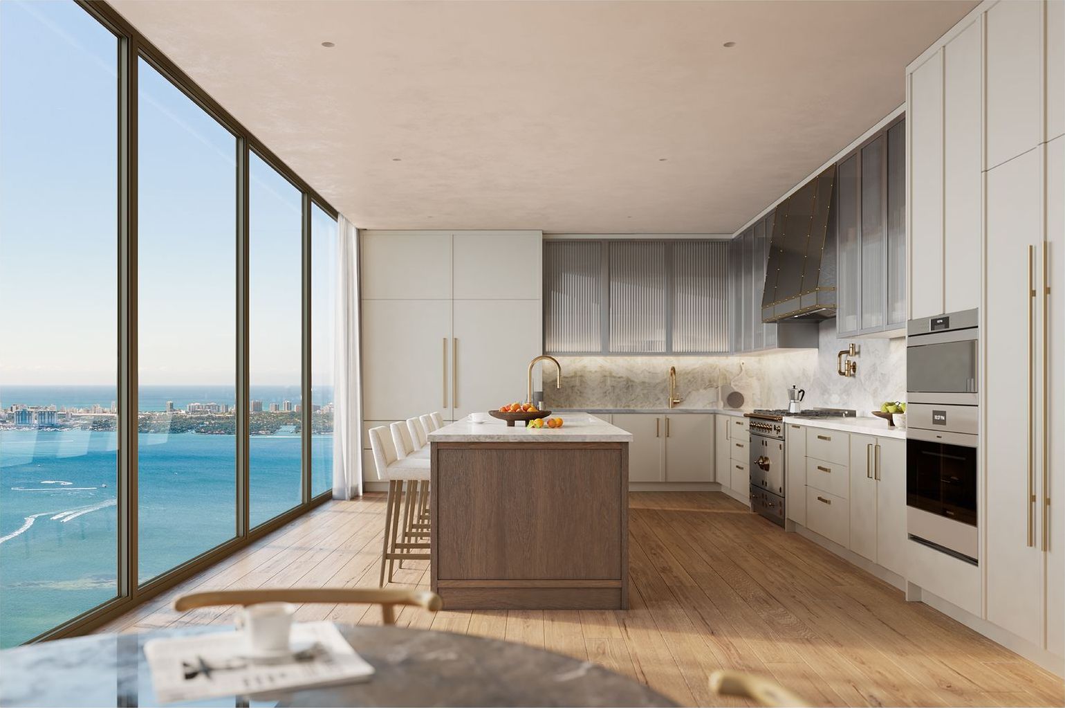 Kitchen with cream lacquer cabinetry and a white oak island facing the bay at Villa Miami, developer rendering