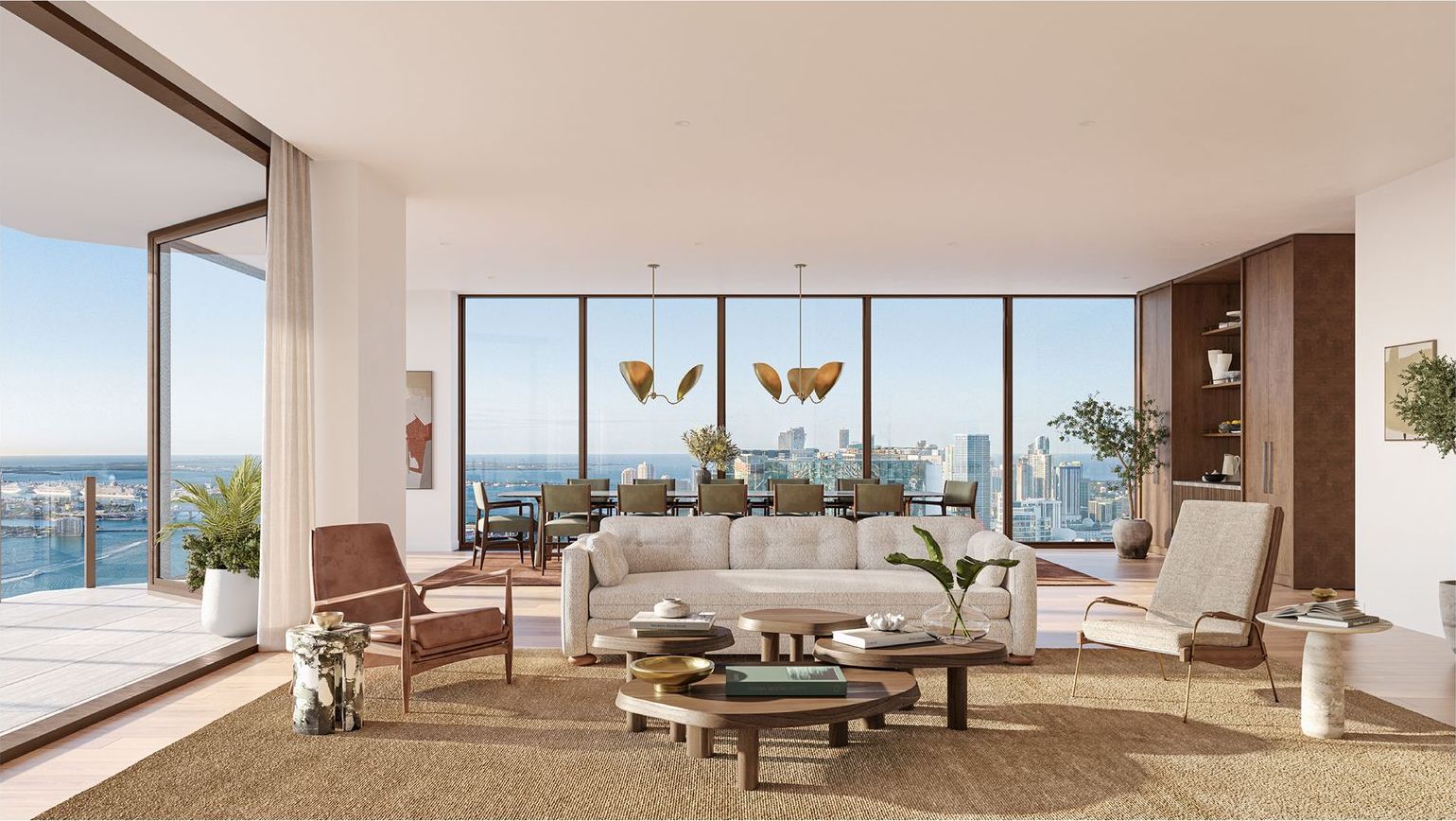 Living room of a Villa Miami residence with floor-to-ceiling glass over Biscayne Bay, developer rendering